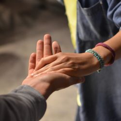 man and woman holding hands on street