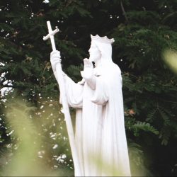 white angel statue near green leaf tree