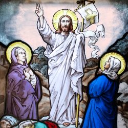 a stained glass window depicting jesus and other people